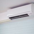 Wall-mounted heat pump cooling a bright, sunlit living room in a New Zealand home during summer