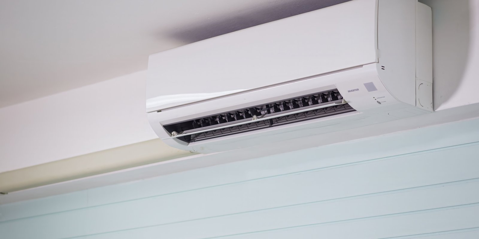 Wall-mounted heat pump cooling a bright, sunlit living room in a New Zealand home during summer