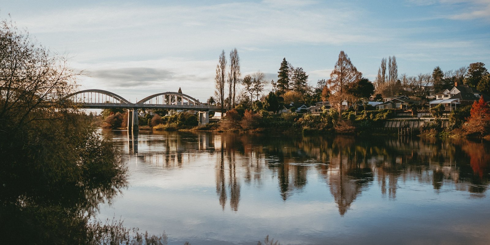 Beautiful autumn scene of the Waikato River with Fairfield Bridge and quaint houses in Hamilton, New Zealand