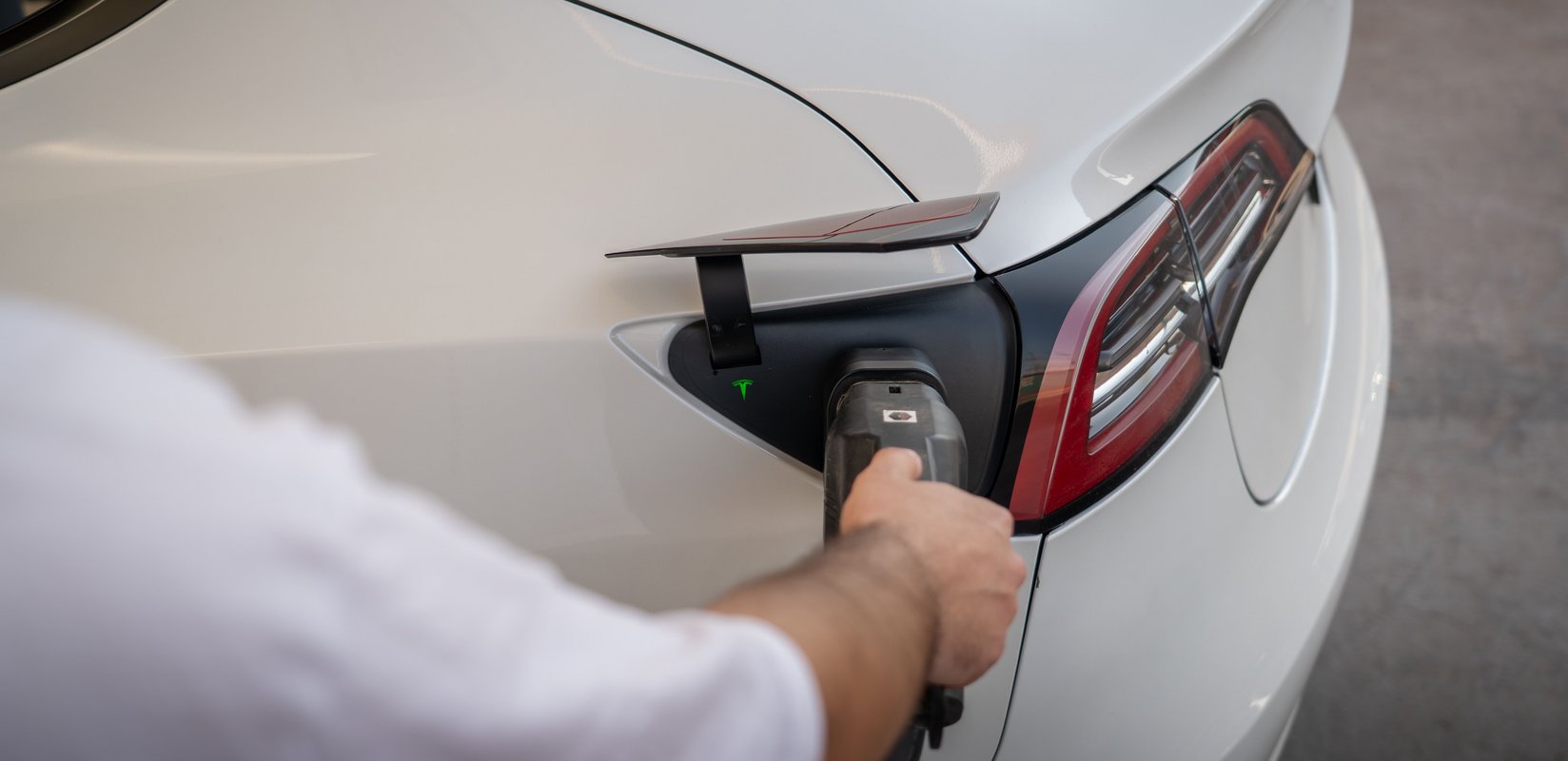 Electric car plugged into a wall-mounted EV charger of a New Zealand family home