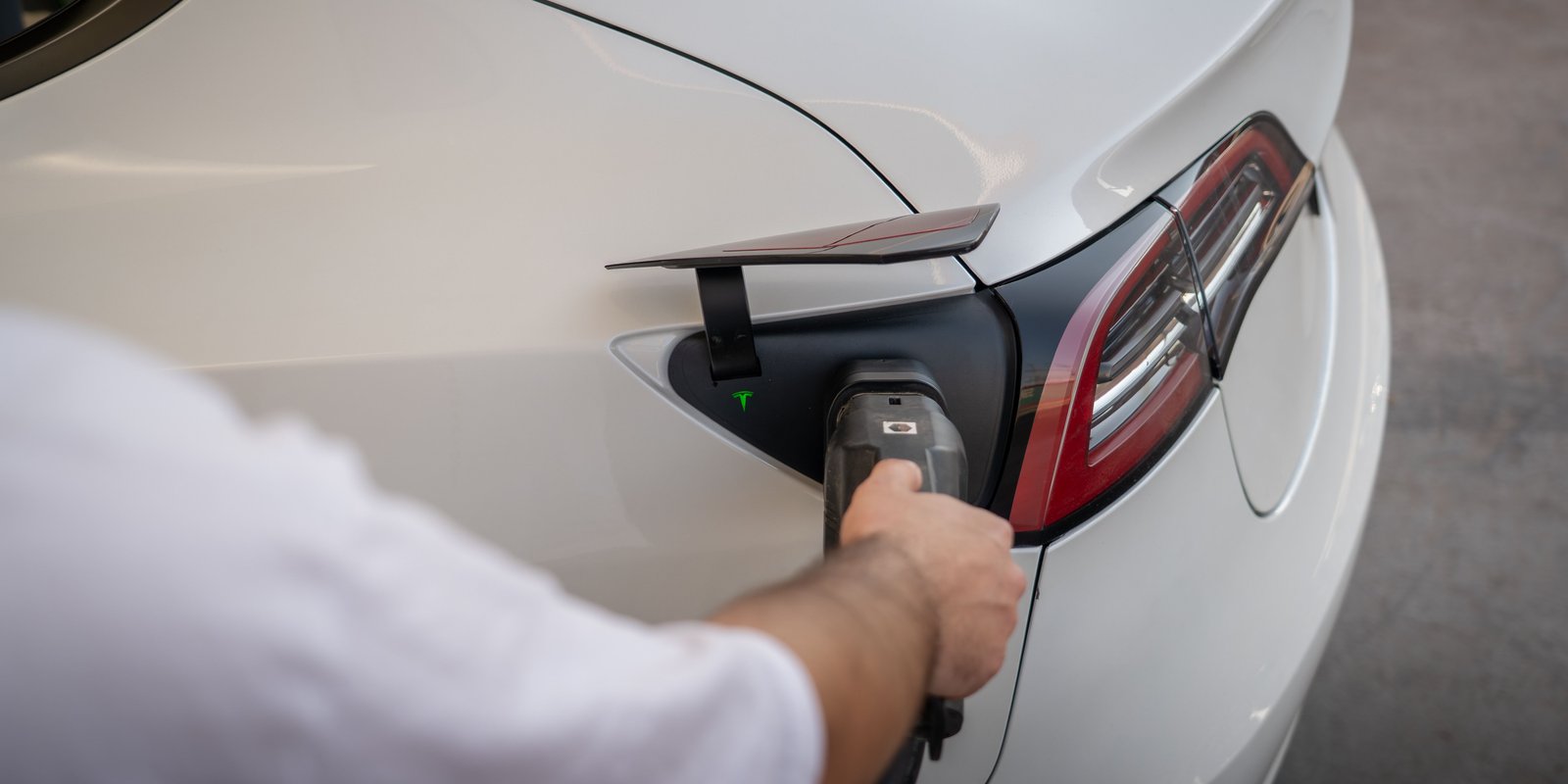 Electric car plugged into a wall-mounted EV charger of a New Zealand family home
